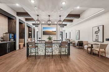 A modern living room with a wooden floor and a large painting